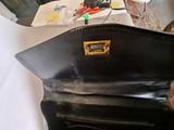 a black purse that is sitting on a table