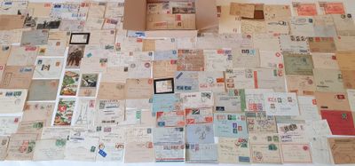 a box that is sitting on top of a table covered in postcards