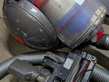 a vacuum that is sitting on the ground next to a car