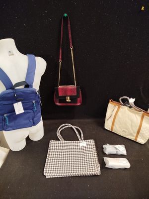a mannequin with a purse, purse, and other items on display