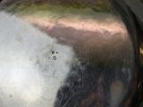 a reflection of a person in a mirror on the side of a wall