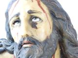 a statue of jesus with blood on his face