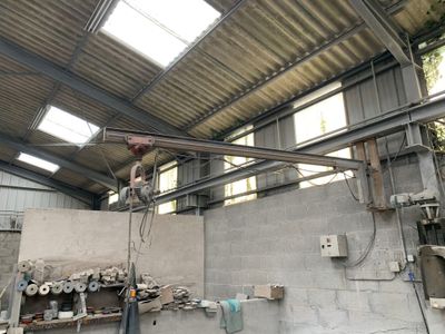 a man that is standing on a crane in a building