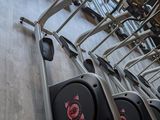 a row of tread machines in a gym room