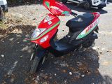 a scooter that is parked on the side of the road
