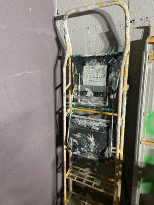 a ladder that is leaning against a wall in a room