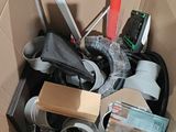 a cardboard box filled with assorted items and tools