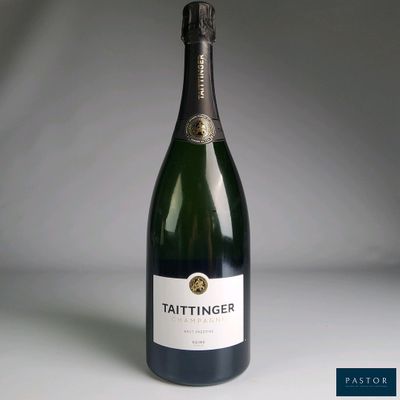 the bottle of wine is sitting on the table ready to be eaten