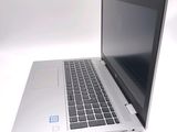 a silver laptop with a blue sticker on the screen