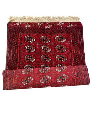 a red rug on a white background with fringes