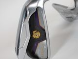a close up of a golf iron on a white surface
