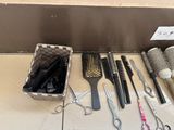 many different types of hair brushes and combs on the floor