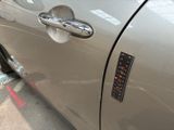 a close up of a car door handle with a sticker on it