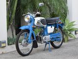 a blue motorcycle parked on the side of the road