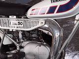 a motorcycle that is parked next to a wall