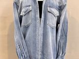 an image of a denim shirt on a mannequin stand