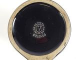 a black and gold plate with a black and white design