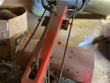 a machine that is sitting on the floor in a garage