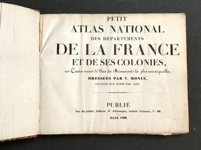 un livre ouvert posé sur une table, sur fond noir