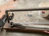 a close up of a metal rail with a bucket of paint on it