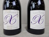 two bottles of wine that are sitting on a table