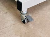 a white bed with a black foot board on it
