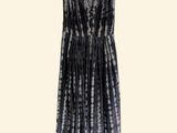 a black and white tie dye dress hanging on a hanger