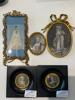 three framed pictures on the wall of a room