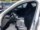 a silver car with a black seat and steering wheel