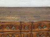 an image of a wooden chest of drawers on a wooden floor