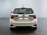the rear end of a white toyota yaris parked in a room