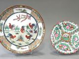 two plates with different designs on them on a table
