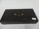 an old black suitcase with a smile drawn on it