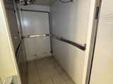 a bathroom with a toilet and a shower in it