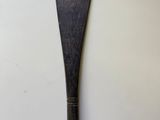 an old wooden paddle sitting on top of a white table