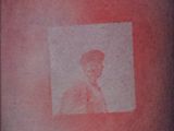 a picture of a man on the back of a man ' s shoulder