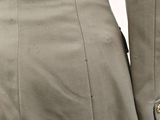the back of a woman ' s dress with buttons on it