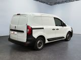 the back of a white van parked inside of a building