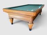 the pool table is made of wood and has a green cloth