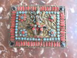 a picture of a decorative box with red and blue stones