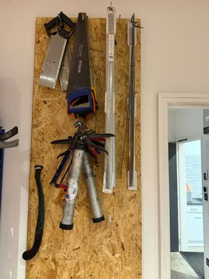 a picture of a wall with tools hanging on it