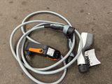 an electric cable connected to a charger on the ground