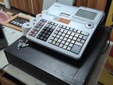 a calculator sitting on top of a table in a kitchen