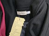 a close up of a suit and tie with a tag on it