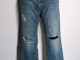 jeans on a mannequin stand on a white wall
