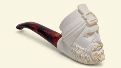 a picture of a pipe with a man ' s head on it