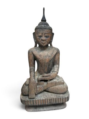 an image of a statue of a person sitting on a rock
