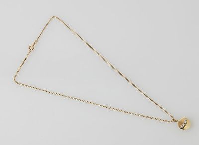 a gold plated necklace with a heart pendant on a white background