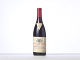 a bottle of red wine sitting on top of a table