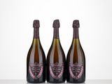 three bottles of wine sitting on top of a table